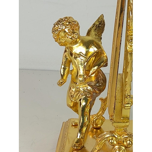 54 - Gilt cast metal cherub mirror, 21cms height