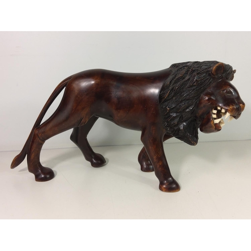 153 - Carved wooden lion figure, height 22cms, length 42cms