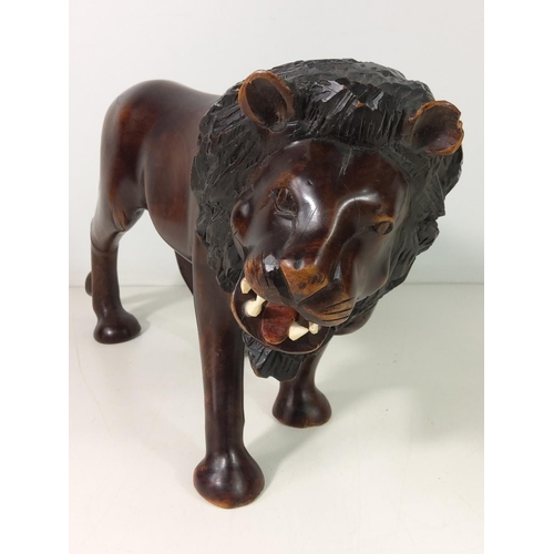 153 - Carved wooden lion figure, height 22cms, length 42cms