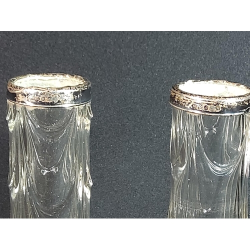 310 - Pair of silver top vases, height 20cms