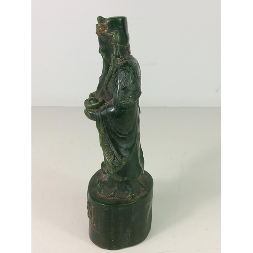 307 - Carved jade green figure of an Oriental God, approx 21cms tall