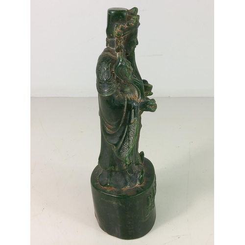 307 - Carved jade green figure of an Oriental God, approx 21cms tall