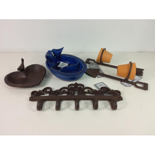 213 - Cast iron bird bath, ceramic bird feeder, 2 pot holders with pots and cast iron wall hanger