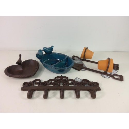 215 - Cast iron bird bath, ceramic bird feeder, 2 pot holders with pots and cast iron wall hanger