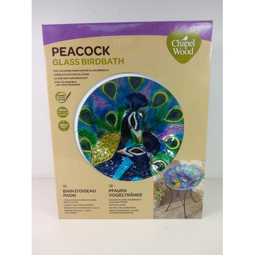 226 - Glass peacock bird bath, new and boxed