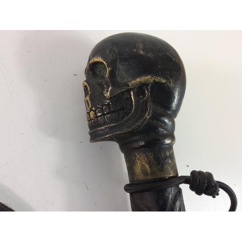 30 - Carved walking stick with metal skull top