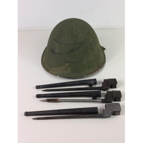 690 - Vintage tin helmet and 3 pig stick bayonets