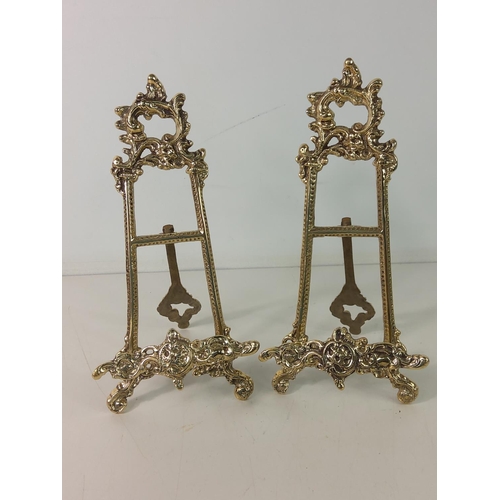 142 - Pair of brass easels, 22cms in height