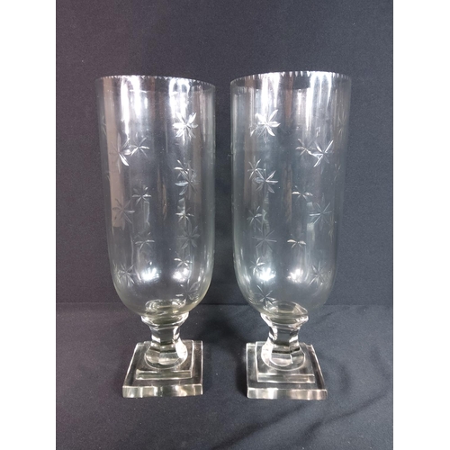 303 - Pair of glass hurricane lamps 61cms in height x 12cms diameter