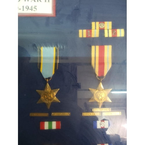 209 - Glass display case of 12 WWII medals, 62cms x 45cms