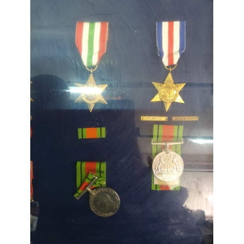 209 - Glass display case of 12 WWII medals, 62cms x 45cms