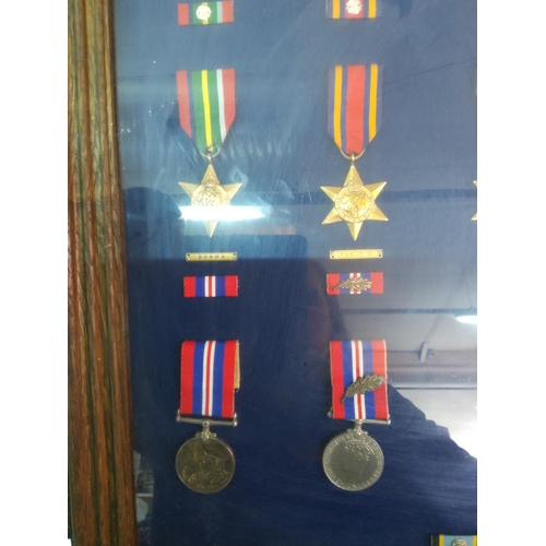 209 - Glass display case of 12 WWII medals, 62cms x 45cms