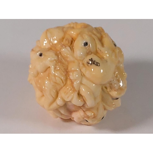 366 - Oriental carved bone animal ball