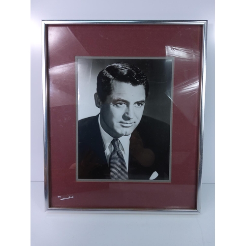 48 - Framed studio photograph of Carey Grant, 32cms x 39cms