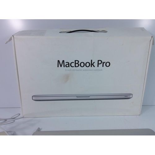 94 - Boxed MacBook Pro with charging lead