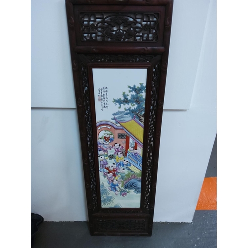 93 - Large Oriental porcelain tile with ornate wooden frame, 120cms x 37cms