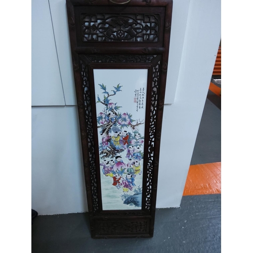 95 - Large Oriental porcelain tile with ornate wooden frame, 120cms x 37cms