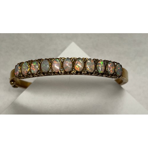 419 - 9ct gold Opal set bangle - 21.7g gross