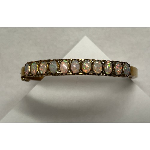 419 - 9ct gold Opal set bangle - 21.7g gross