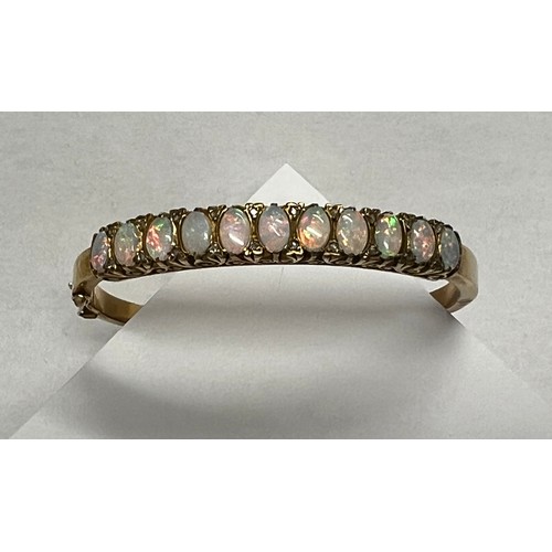 419 - 9ct gold Opal set bangle - 21.7g gross