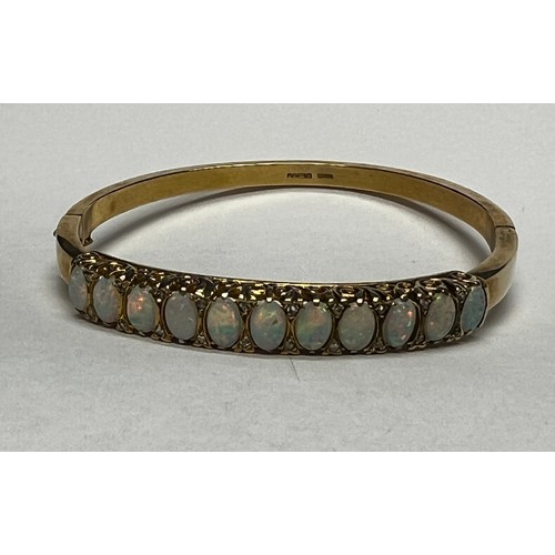 419 - 9ct gold Opal set bangle - 21.7g gross