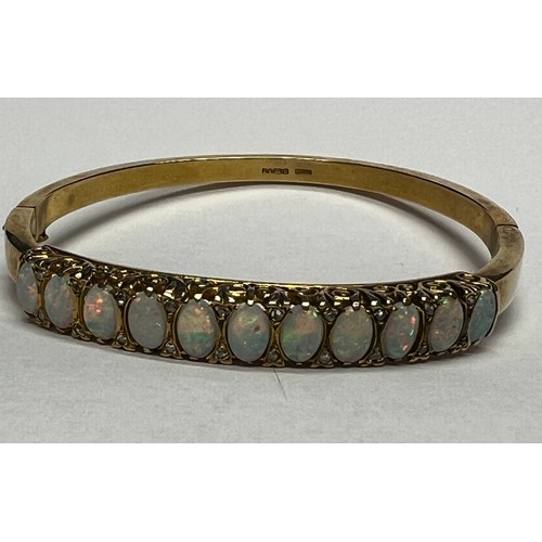 419 - 9ct gold Opal set bangle - 21.7g gross