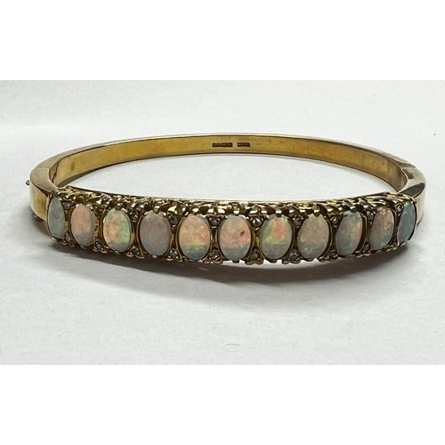 419 - 9ct gold Opal set bangle - 21.7g gross