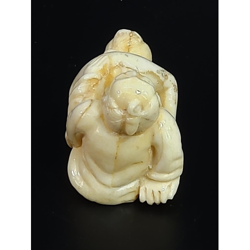 228 - Erotic carved bone netsuke