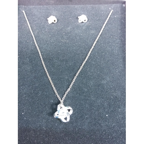 259 - Silver pendant on chain with matching earrings and a bag of earrings