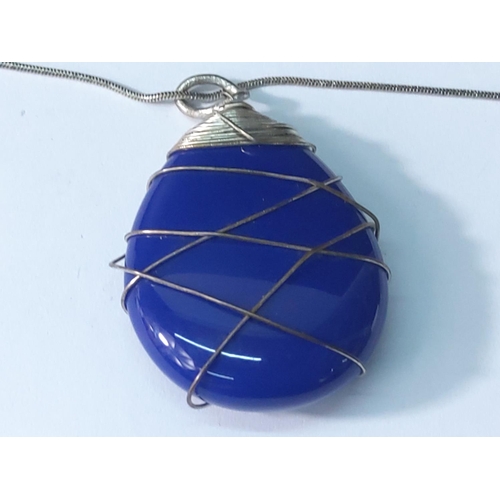 357 - Blue stone pendant on silver chain