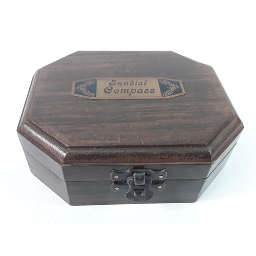 384 - Wooden cased brass compass