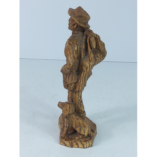 107 - Carved wooden figure of a man and dog