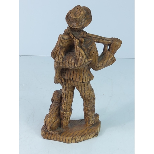 107 - Carved wooden figure of a man and dog