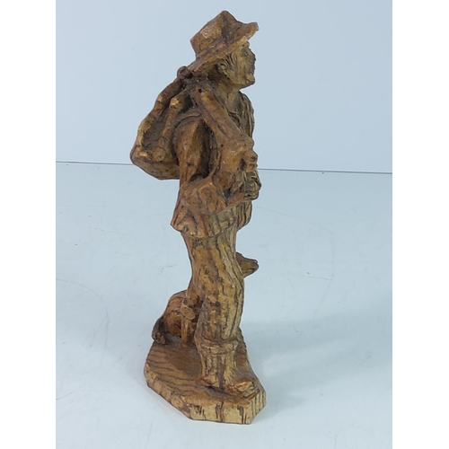 107 - Carved wooden figure of a man and dog