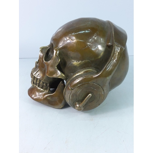 83 - Cast bronze skull with headphones