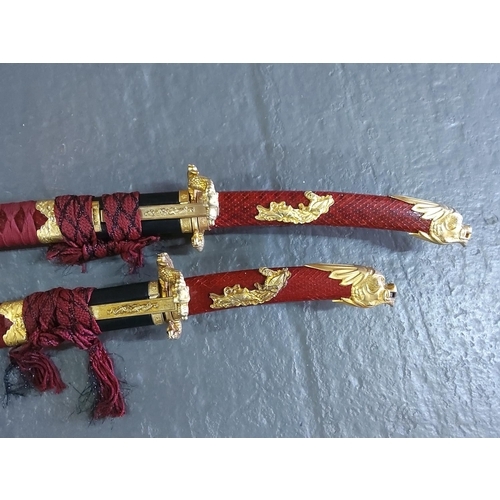 154 - Graduated pair of Samurai swords