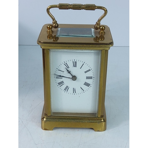 310 - Vintage cased brass carraige clock with key