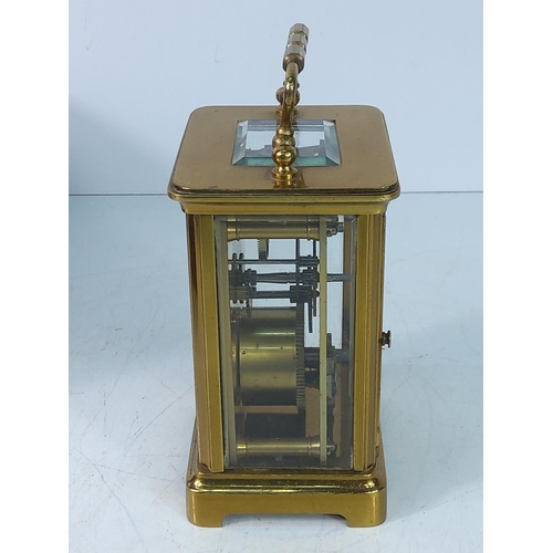 310 - Vintage cased brass carraige clock with key