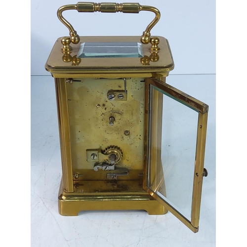 310 - Vintage cased brass carraige clock with key