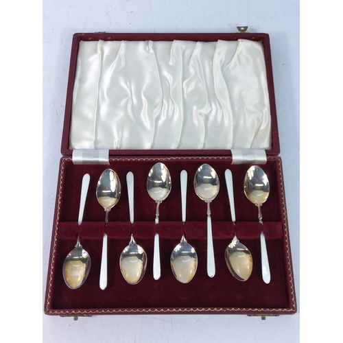 405 - Cased set of 8 silver and enamel floral tea spoons, gross weight 90g