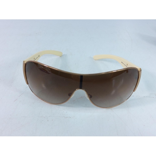 448 - Cased pair of sunglasses with designer label