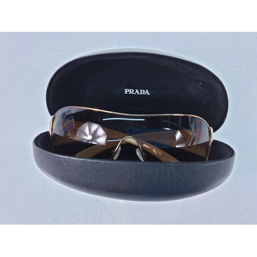 448 - Cased pair of sunglasses with designer label