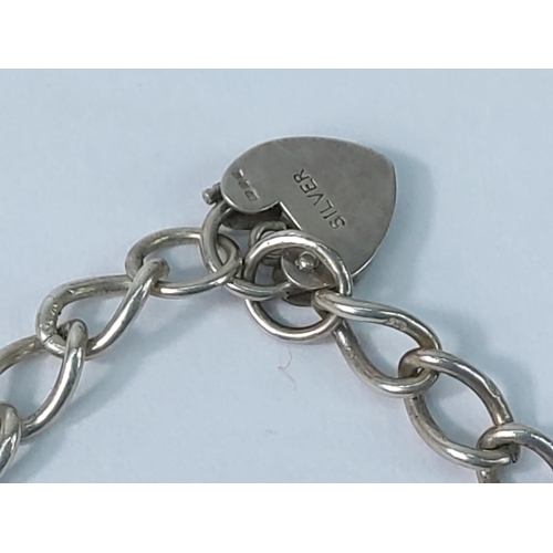 355 - Silver brooch and silver charm bracelet, 26.6g gross