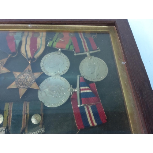 426 - Cased medals, badges, miniatures and a photograph