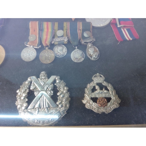 426 - Cased medals, badges, miniatures and a photograph