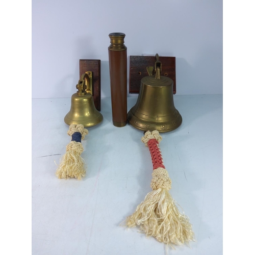 73 - 2 brass bells with pulls and a leather bound telescope