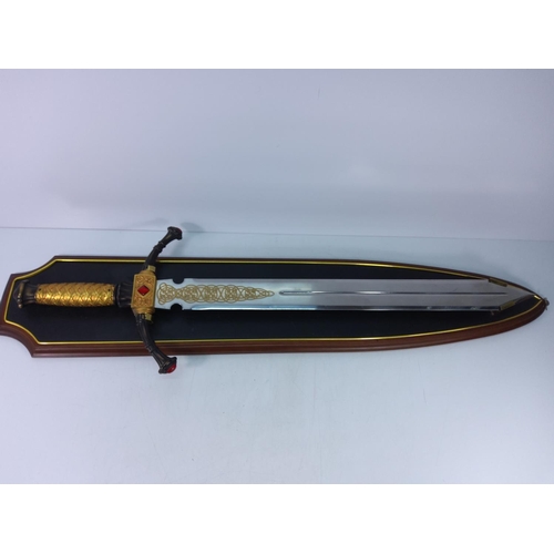 121 - Ornate wooden mounted Franklin Mint sword with Celtic detail to blade, approx 110cms