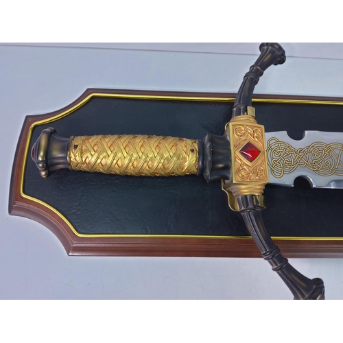 121 - Ornate wooden mounted Franklin Mint sword with Celtic detail to blade, approx 110cms