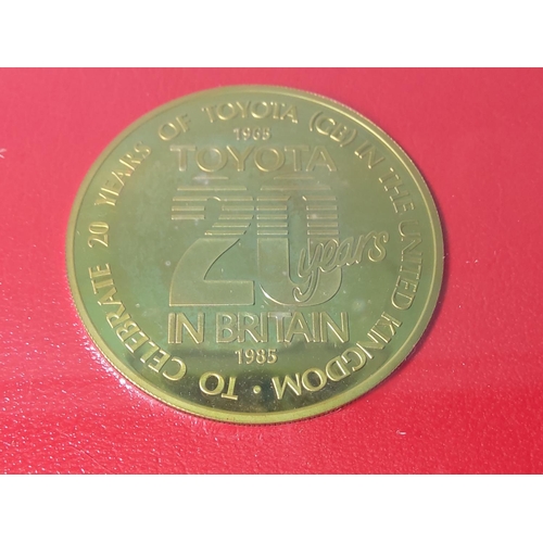 242 - Framed Toyota commemorative coin