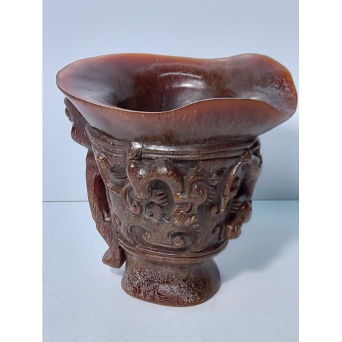 257 - Ornate carved horn libation cup, 13.5 x 13cms